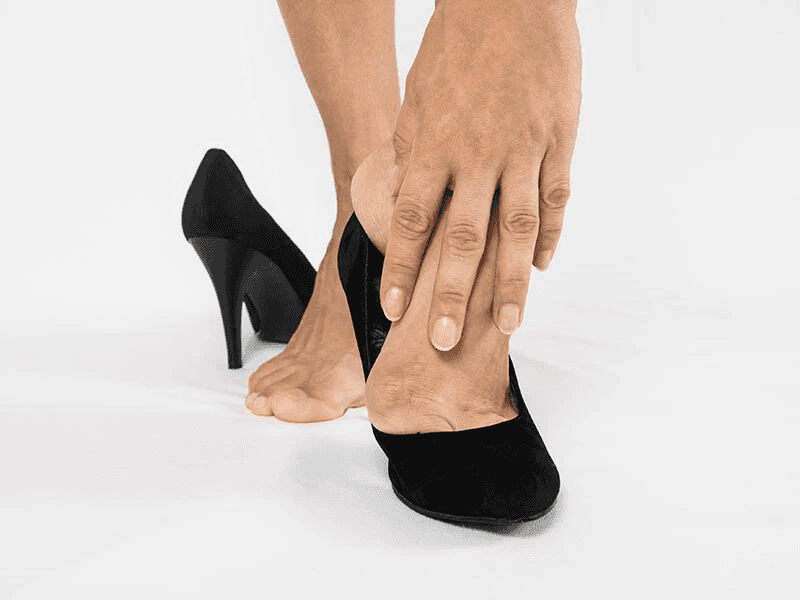 Taking of black high heels